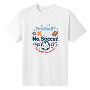 White oversized cotton short‑sleeve t‑shirt, front playful kawaii circular “Football? No, Soccer.” typography print with cartoon soccer ball, crossed football, colorful star and heart details, casual pro‑soccer sports‑themed tee flat lay