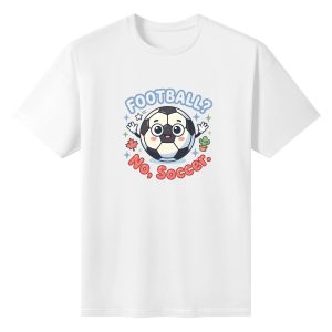 White oversized cotton short‑sleeve t‑shirt, front adorable big‑eyed waving soccer ball cartoon print with curved “Football? No, Soccer.” typography, maple leaf, cactus and star details, casual pro‑soccer North‑America‑themed tee flat lay