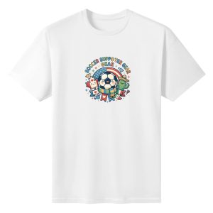 White oversized cotton short‑sleeve t‑shirt, front vibrant circular “Soccer Supporter Gear” typography print with kawaii soccer‑ball, Canada‑USA‑Mexico themed cartoon elements including maple leaf, cactus, flag and scarf details, casual pro‑soccer sports‑themed tee flat lay