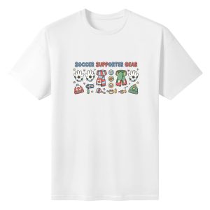 White oversized cotton short‑sleeve t‑shirt, front playful horizontal “Soccer Supporter Gear” typography print with kawaii soccer fan doodles: cheering gloves, national‑themed scarves, country‑branded beanies, musical fan instruments and star‑heart accents, casual pro‑soccer sports‑themed tee flat lay