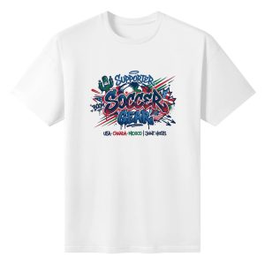 White oversized cotton short‑sleeve t‑shirt, front edgy urban graffiti‑style “Supporter Soccer Gear” typography print with grunge splatter effects, soccer ball, cactus, national flag accents and joint‑host text, casual pro‑soccer sports‑themed tee flat lay