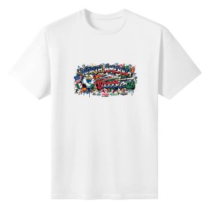 White oversized cotton short‑sleeve t‑shirt, front colorful urban graffiti‑style “North America Soccer 2026” typography print with grunge splatter‑drip effects, central flag‑themed soccer ball, host‑country flags, fiery street‑art details and joint‑host text, casual pro‑soccer sports‑themed tee flat lay