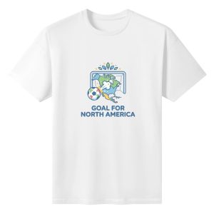 Plain white short‑sleeve crew‑neck t‑shirt featuring clean flat‑design soccer‑goal graphic with North America map silhouette, playful kicking soccer ball, subtle star‑leaf crown details and simple uppercase patriotic slogan