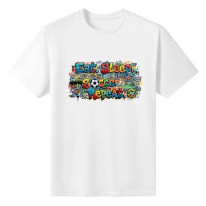 Plain white short‑sleeve crew‑neck t‑shirt featuring wide horizontal colorful graffiti‑style slogan, dense doodle‑art elements of soccer gear, player silhouettes, food items and dynamic grunge splash details