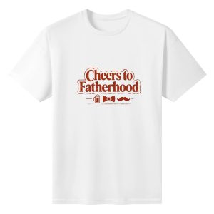 Plain white short‑sleeve crew‑neck t‑shirt featuring retro‑style “Cheers to Fatherhood” slogan, with dad‑themed icons (beer mug, bow tie, mustache) and a vintage vibe