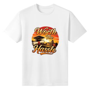 White crewneck T-shirt with a retro sunset-style “Worth The Hassle” graphic, featuring a graduation cap, diploma, and classic campus silhouette.