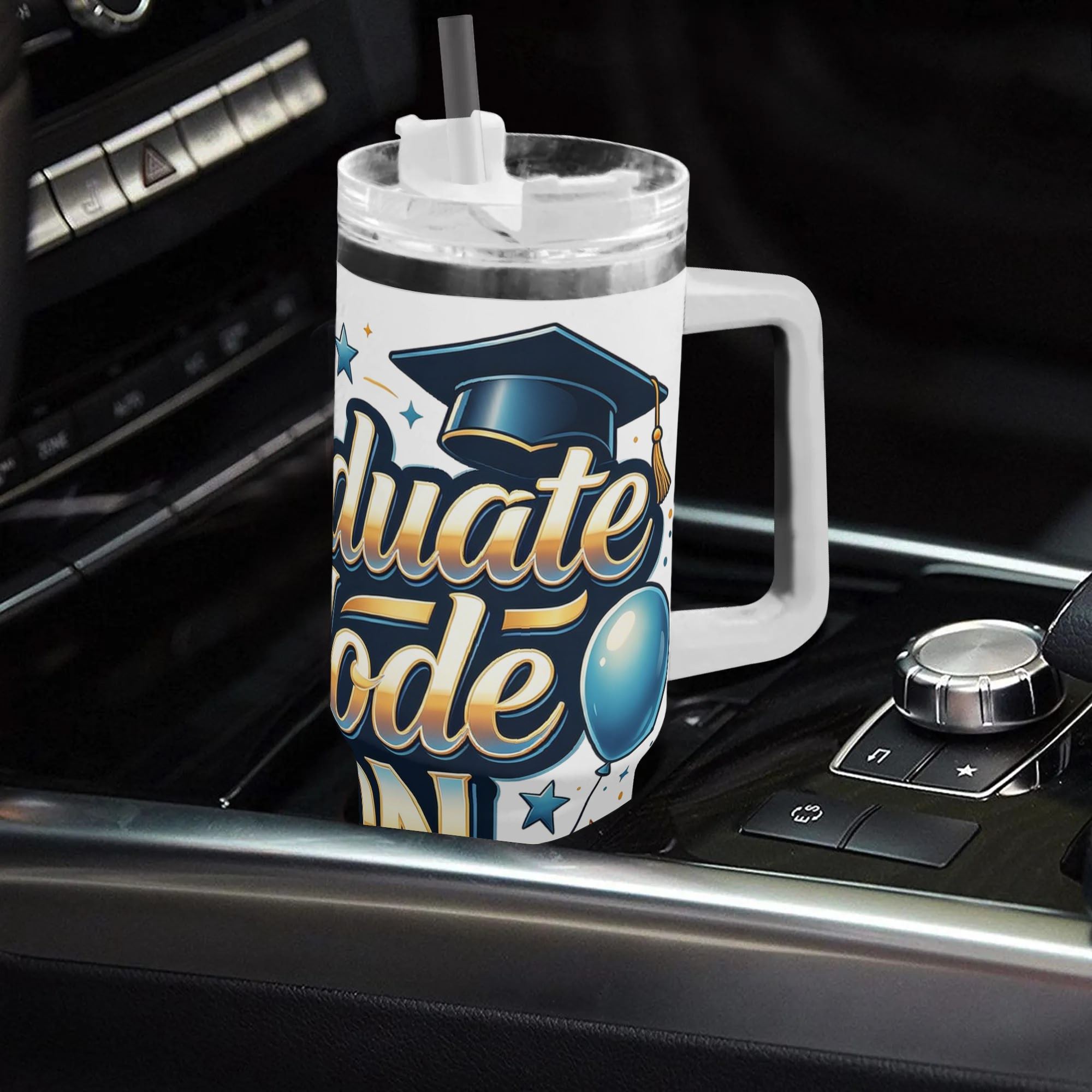 "Graduate Mode ON" tumbler placed in a car cup holder, showing its fit for on-the-go use.