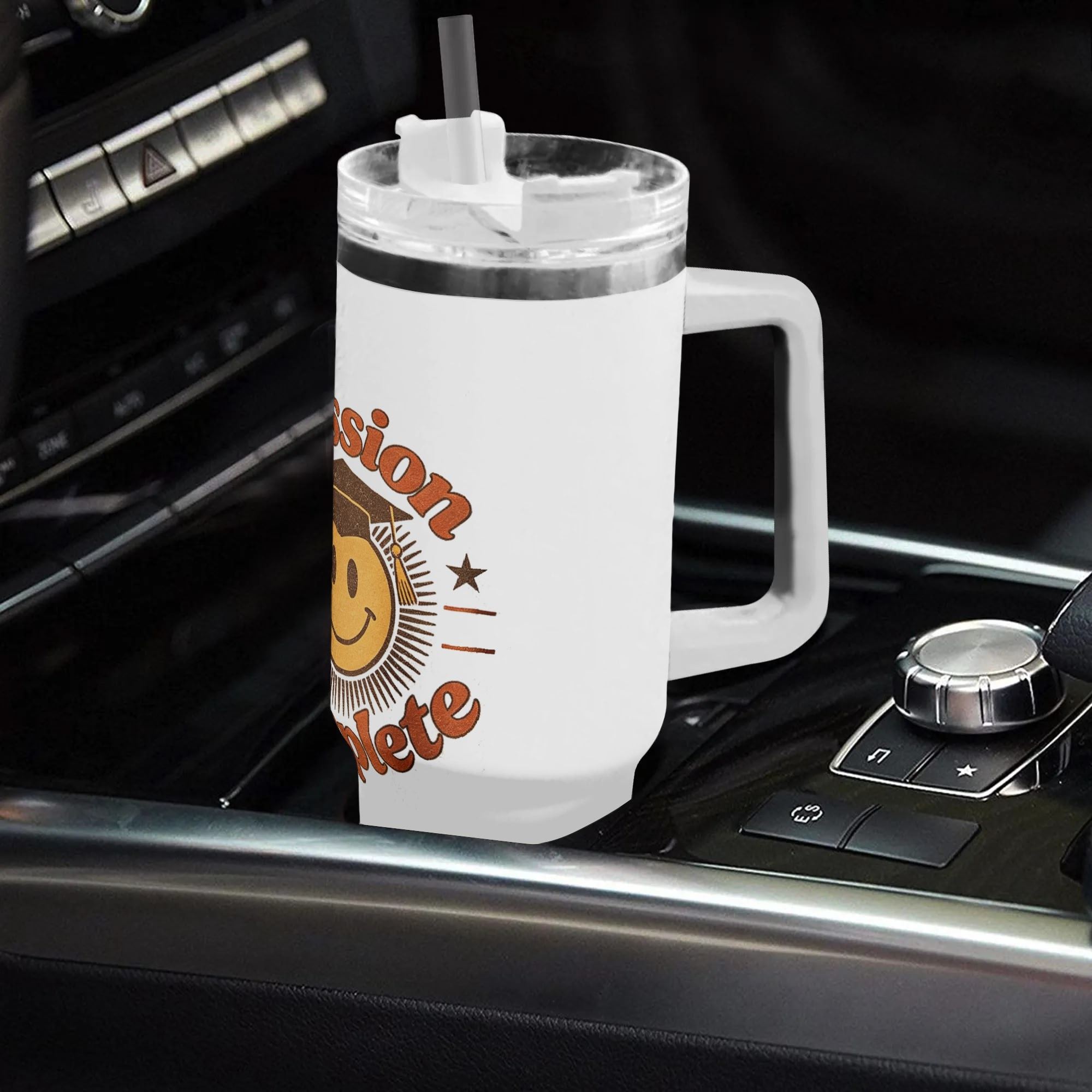 "Mission Complete" tumbler placed in a car cup holder, showing its fit for on-the-go use.
