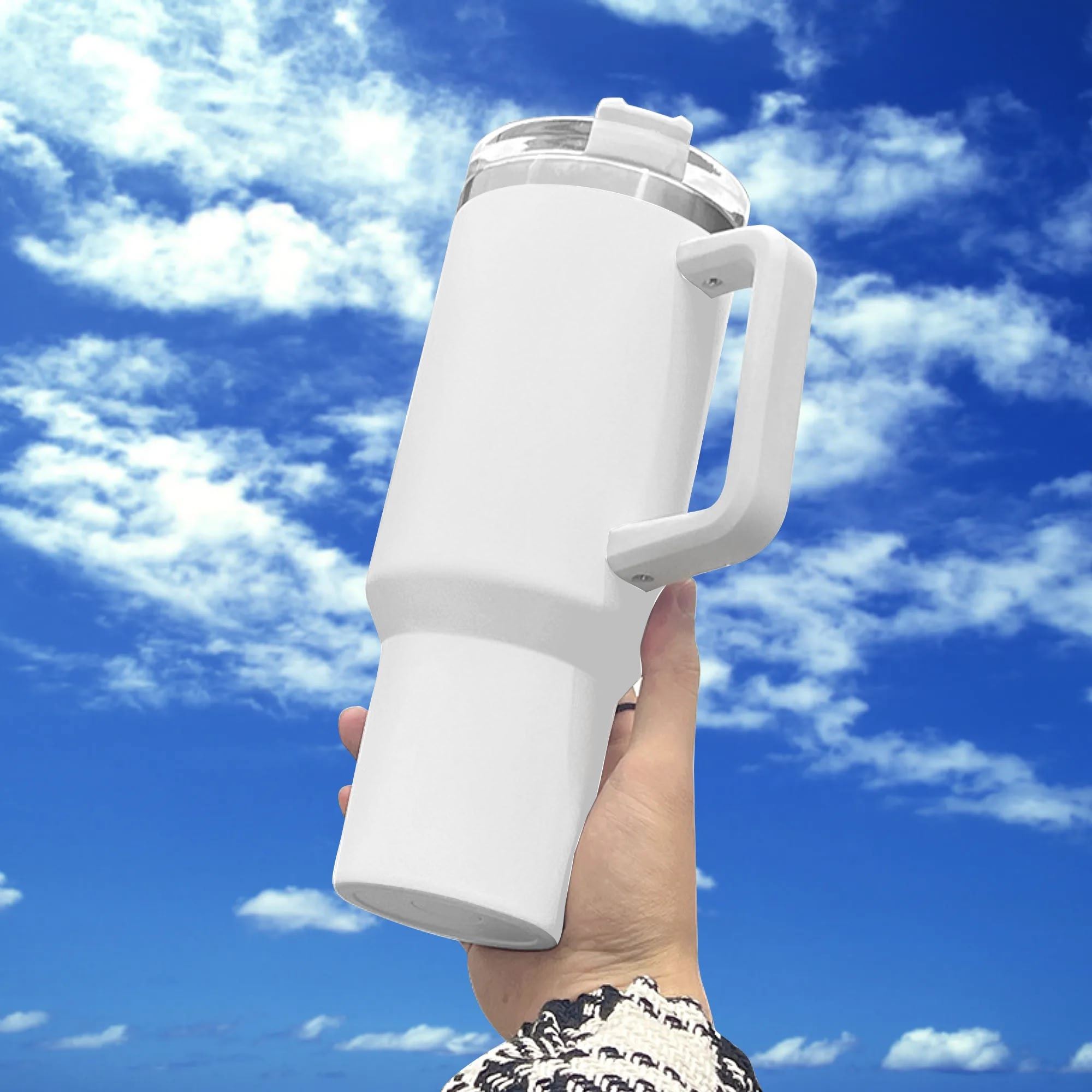 40oz white stainless steel tumbler with handle, featuring a vibrant "United by Football" multicolor soccer design, held against a bright sky.