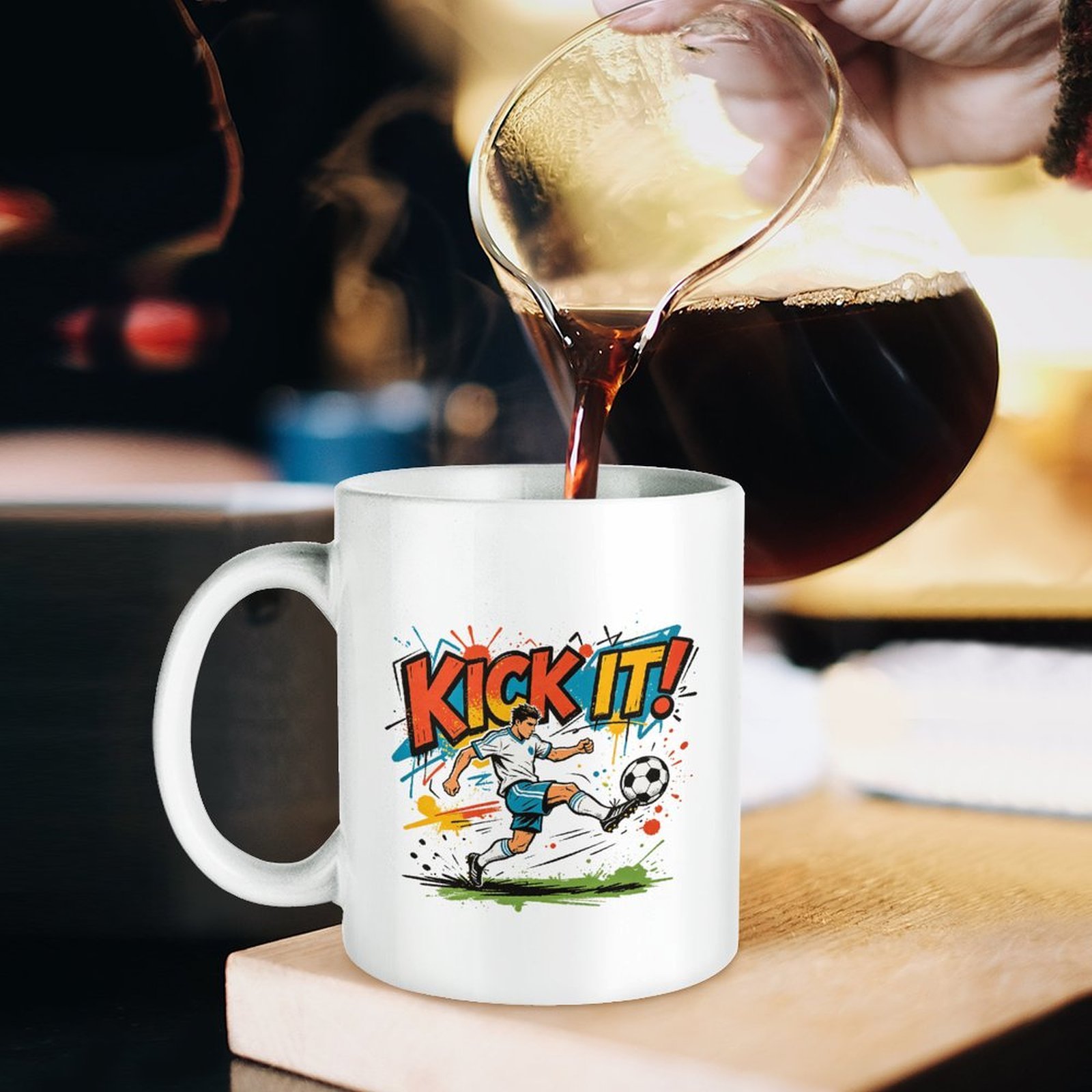 “Kick It!” soccer‑themed mug in use, with coffee being poured into it, showcasing the vibrant World Cup‑ready street‑art soccer graphic.