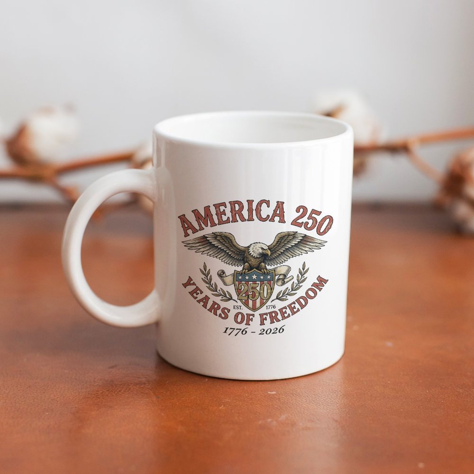Classic "America 250" mug styled on a wooden table, showcasing the retro patriotic print with an eagle and 1776-2026 anniversary details.