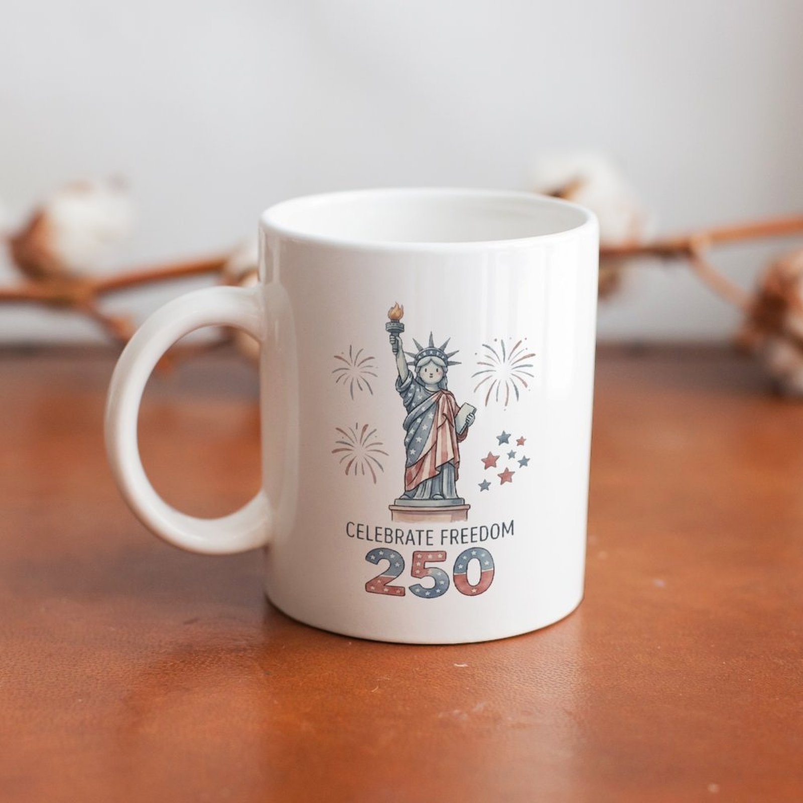 Watercolor-style Statue of Liberty mug on a wooden table, showcasing the soft, festive print for everyday use.