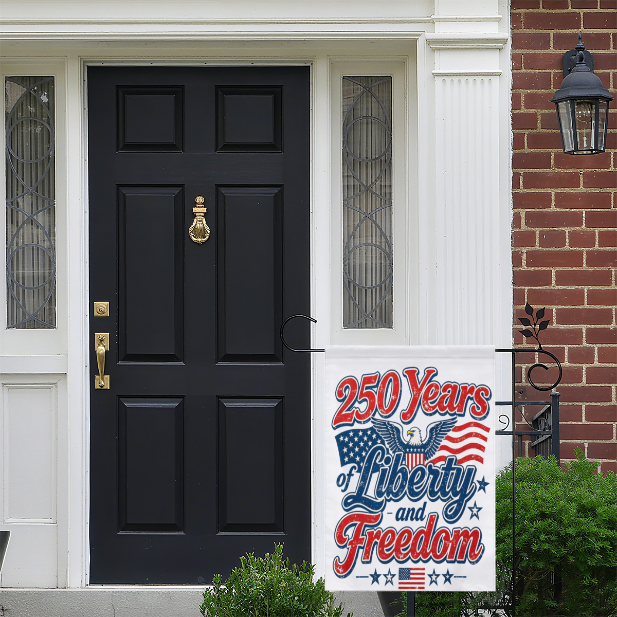 Lifestyle shot of the garden flag displayed by a front door, showing its festive patriotic design against a residential exterior