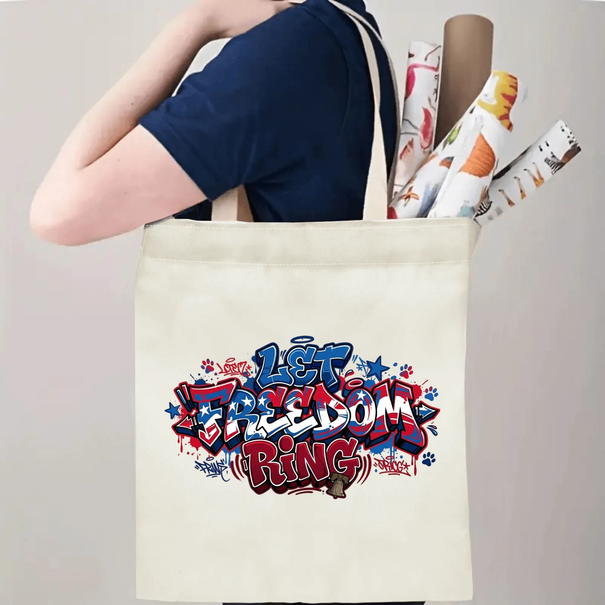 Model carrying graffiti-style Let Freedom Ring patriotic canvas tote for daily errands and casual outdoor use