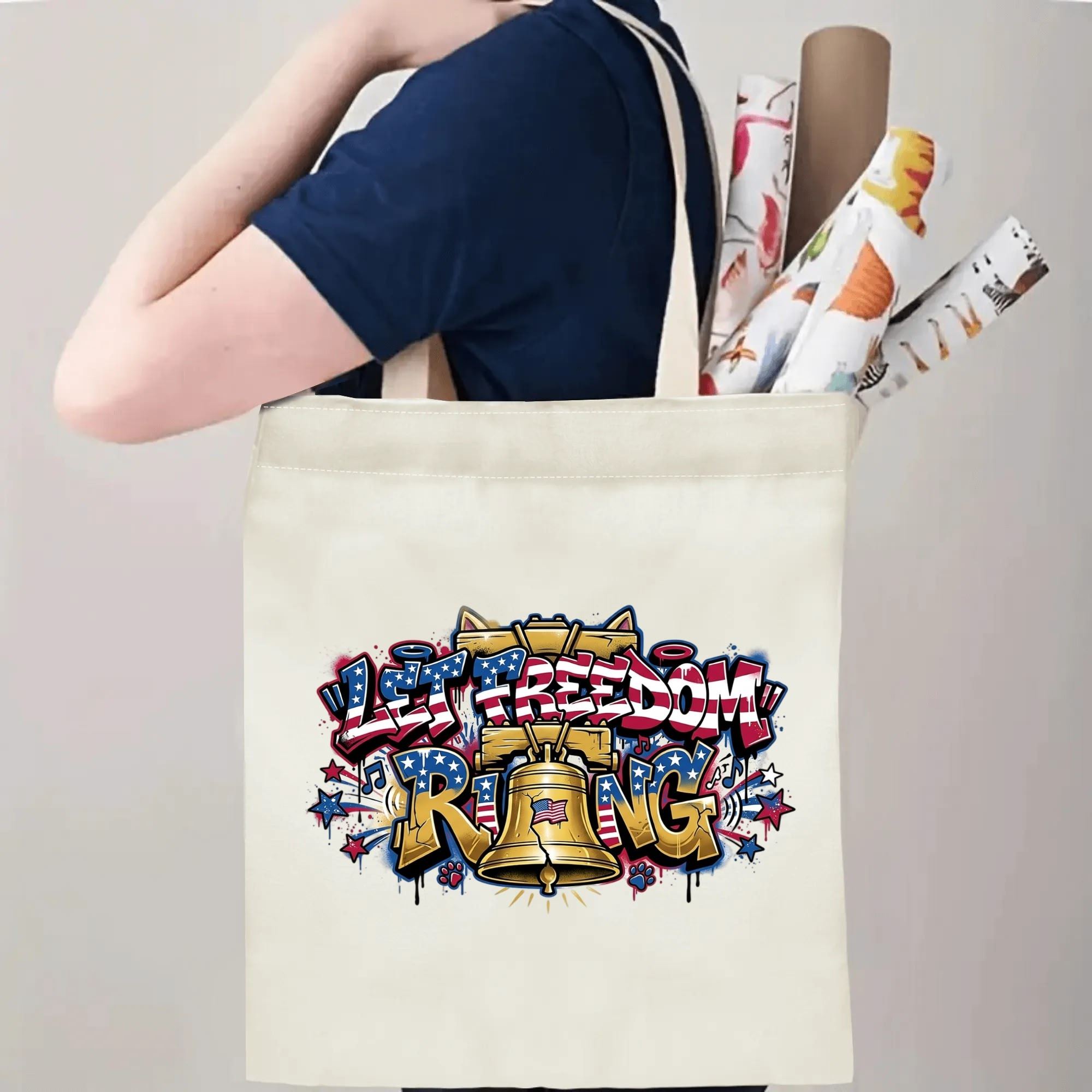 Wear model shot: Person shoulder-carrying drip graffiti Liberty Bell printed canvas tote for daily shopping and casual outing
