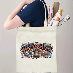 Person carrying multi-color graffiti eagle dove Liberty Bell printed canvas tote for daily shopping and casual outdoor use