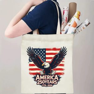 Person carrying vintage eagle USA flag print canvas tote bag, patriotic casual reusable shoulder bag for daily errands