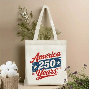 Patriotic tote bag styled with dried flowers, showing the front print clearly