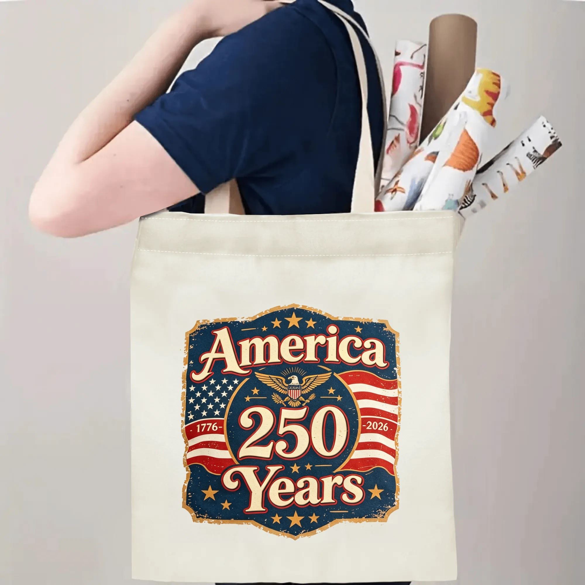 Person wearing the tote bag on their shoulder, showing handle length and print placement