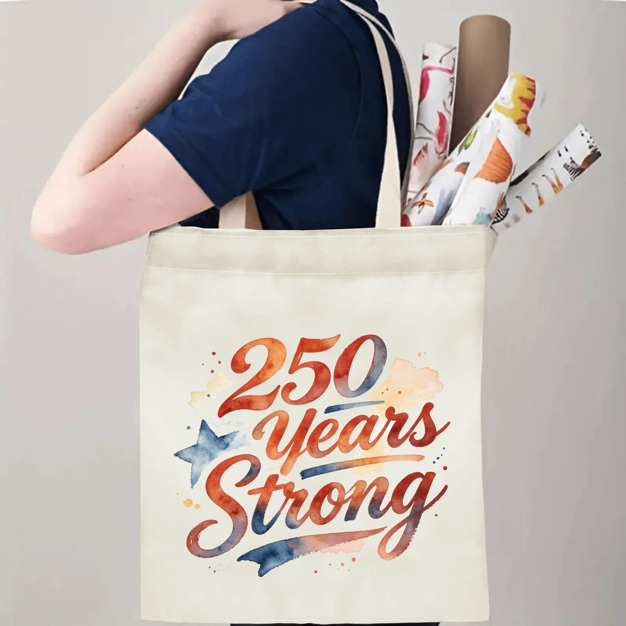 Person carrying the “250 Years Strong” tote bag, showing handle length and print placement