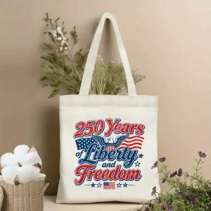 Patriotic tote bag with “250 Years of Liberty and Freedom” eagle and flag print, styled with dried flowers in a home setting.