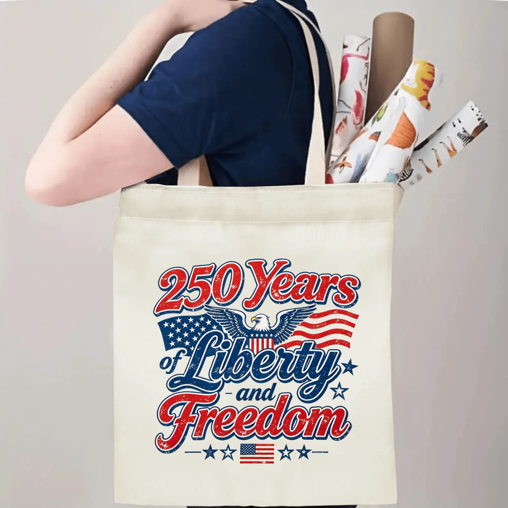 Person carrying the “250 Years of Liberty and Freedom” tote bag, demonstrating handle length and print placement when worn.