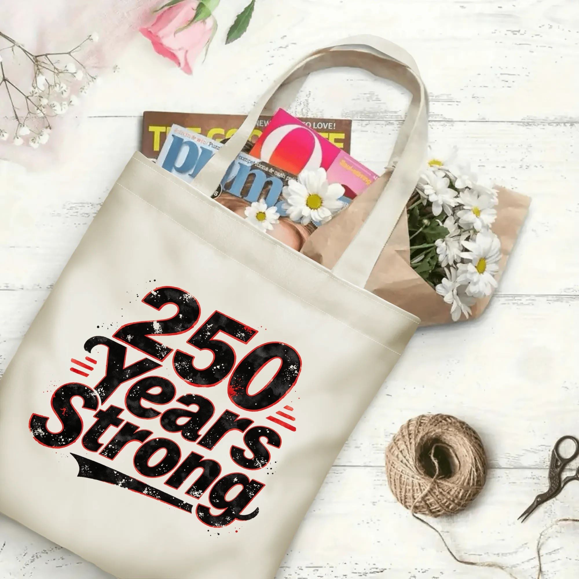 Open “250 Years Strong” tote bag filled with books and flowers, showcasing the spacious interior and full print design