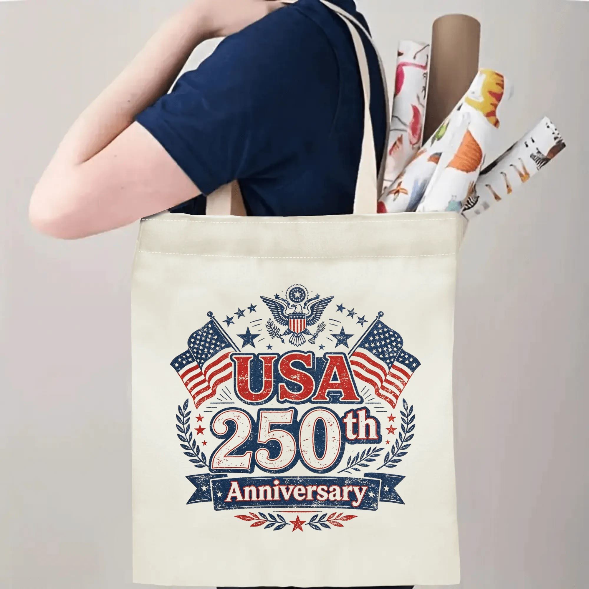 Person carrying the “USA 250th Anniversary” tote bag, demonstrating handle length and print placement when worn