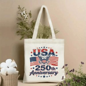 Lifestyle shot of the “USA 250th Anniversary” canvas tote bag, styled with dried flowers in a home setting