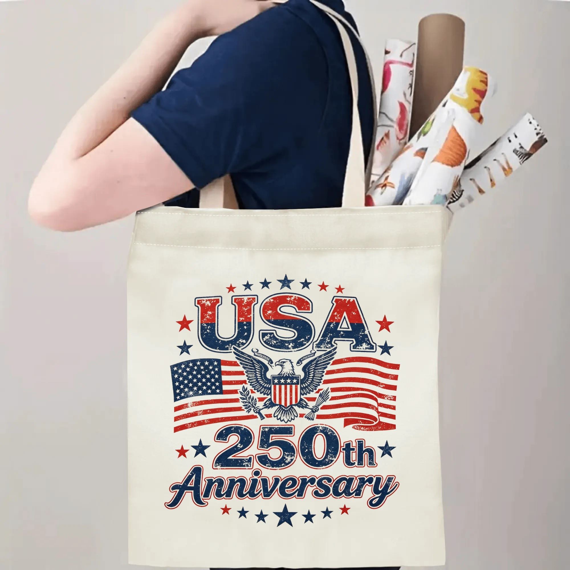 Person carrying the “USA 250th Anniversary” tote bag, demonstrating handle length and print placement when worn