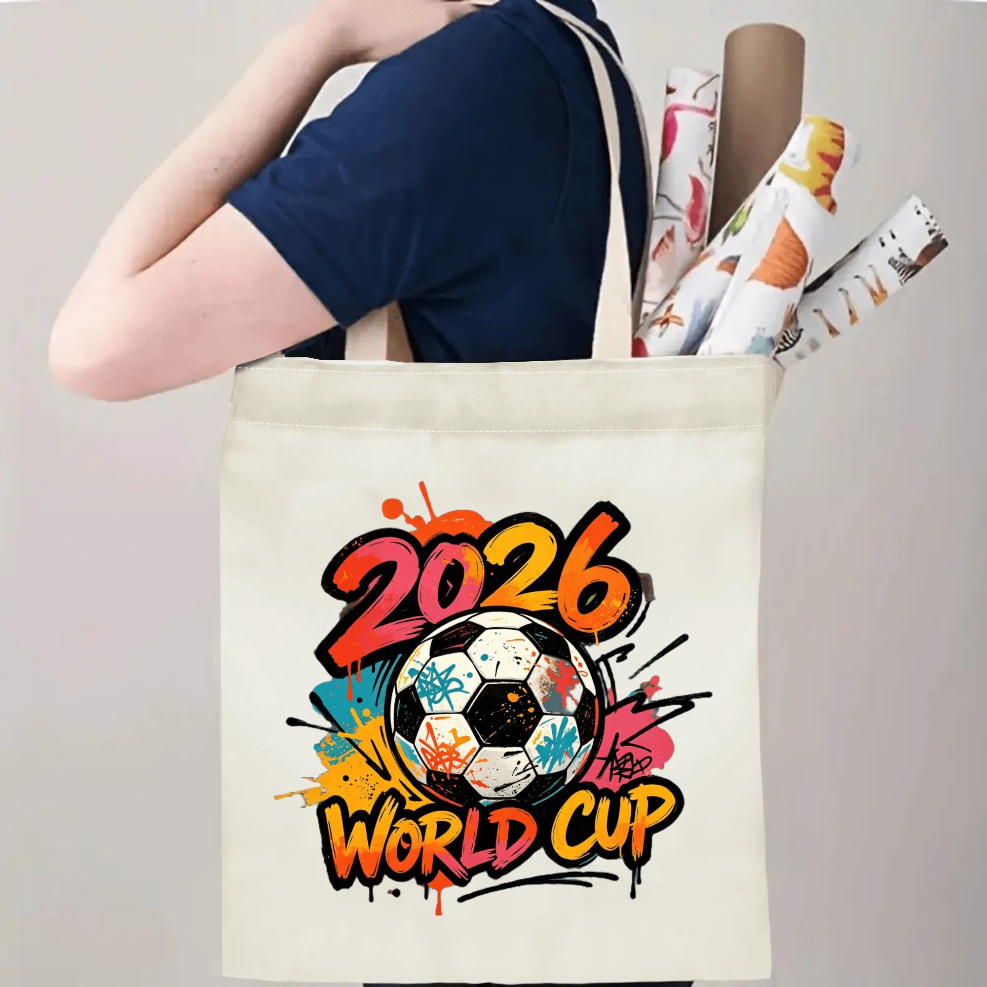Person carrying the “2026 World Cup” graffiti tote bag, demonstrating its size and how it looks when worn over the shoulder.