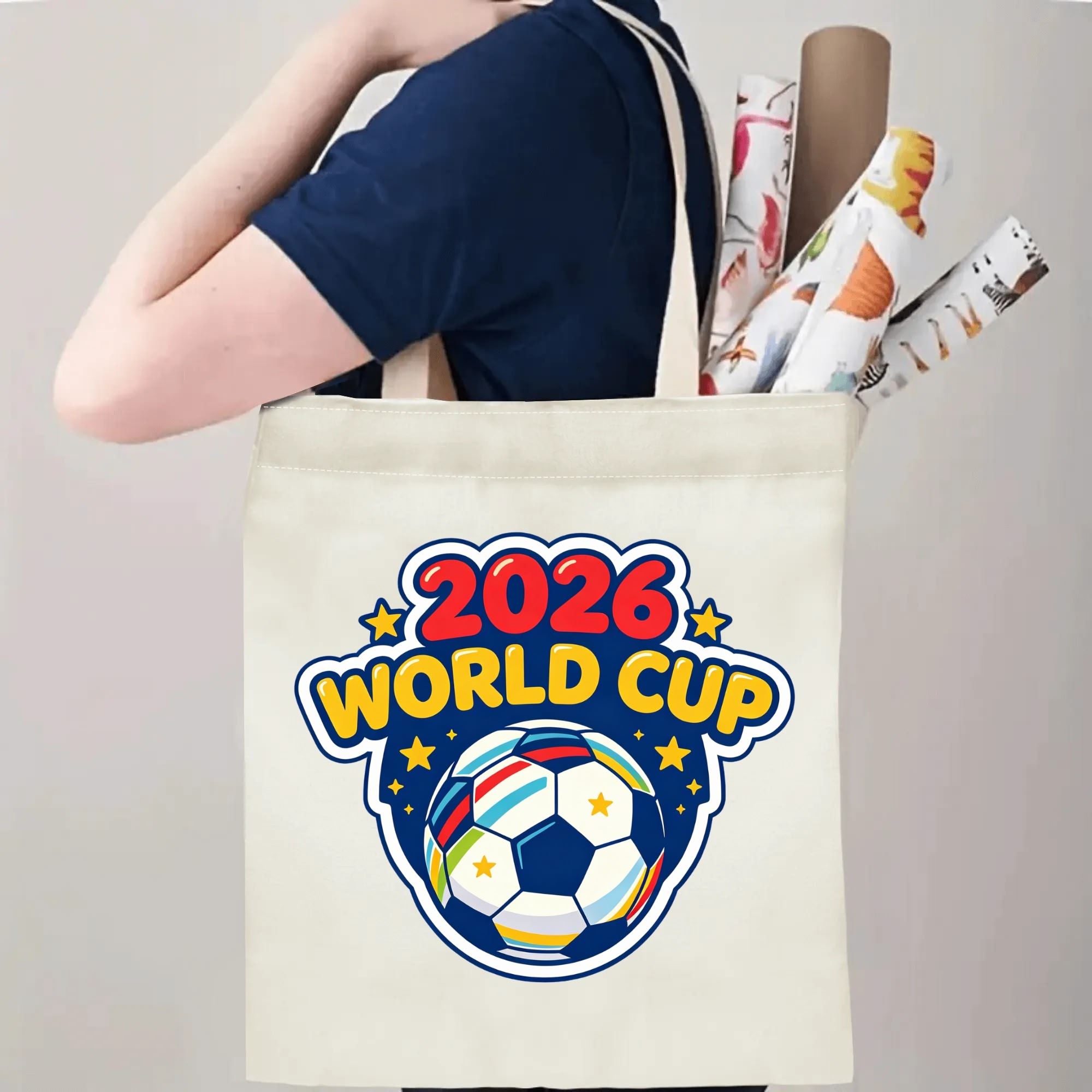 Person carrying the “2026 World Cup” graffiti tote bag, demonstrating its size and how it looks when worn over the shoulder.