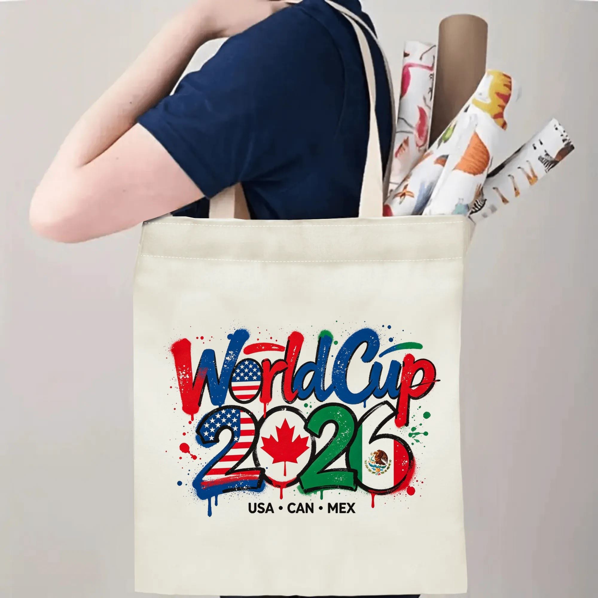 Person carrying the “World Cup 2026” graffiti tote bag over the shoulder, demonstrating its size and practical use.