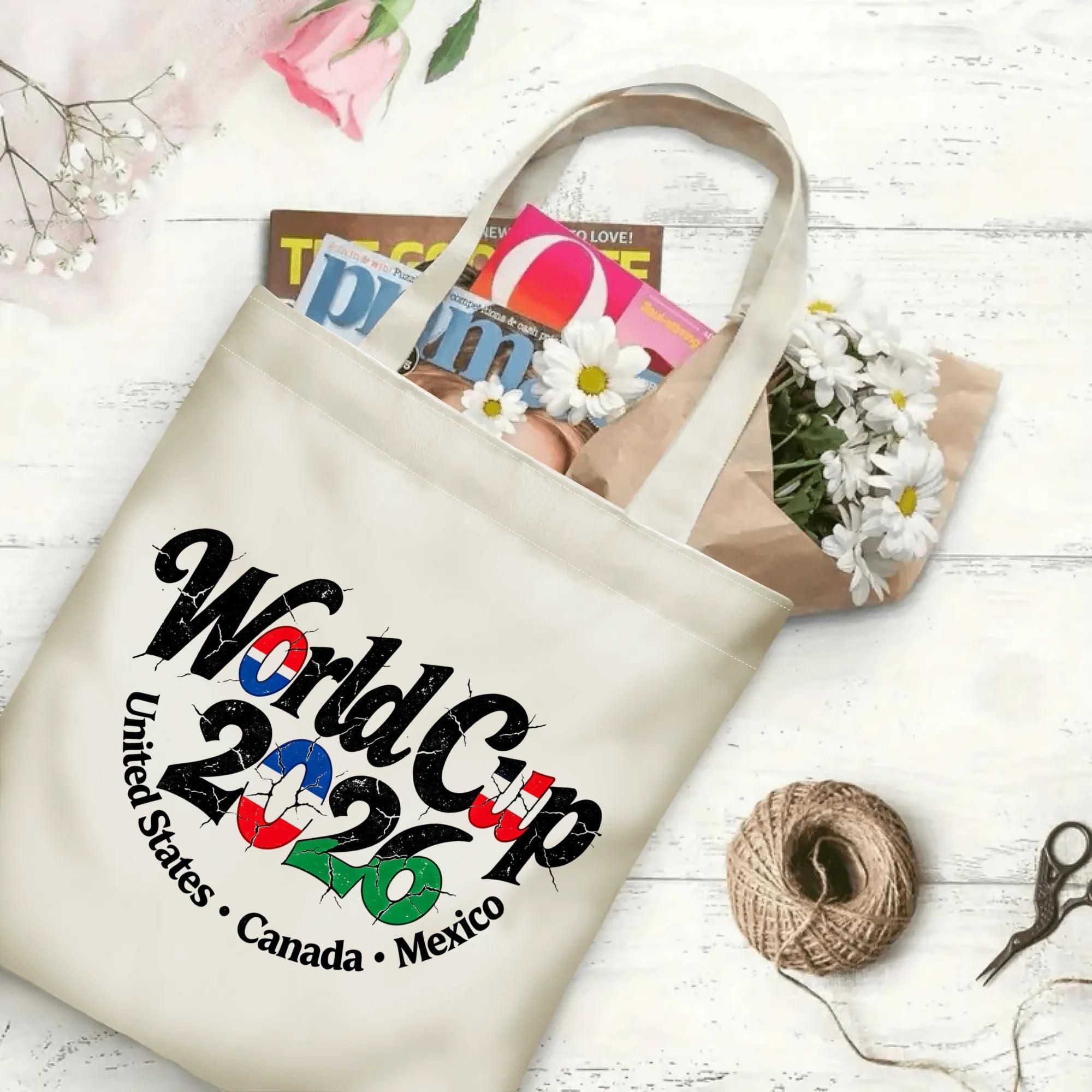 The tote bag in use, filled with books and flowers, showing the “World Cup 2026” print in a casual, everyday setting.