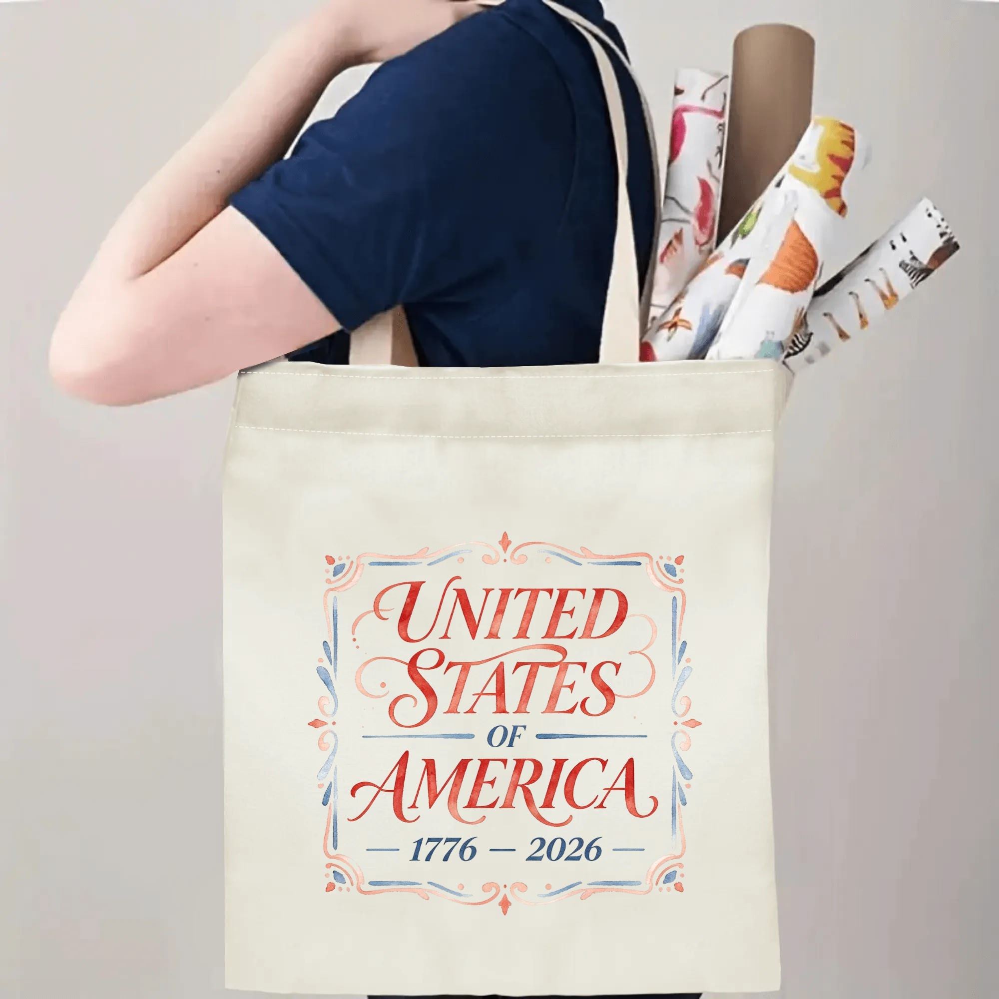 Person wearing the "UNITED STATES OF AMERICA 1776–2026" tote bag over their shoulder, showing its use as a carryall bag.
