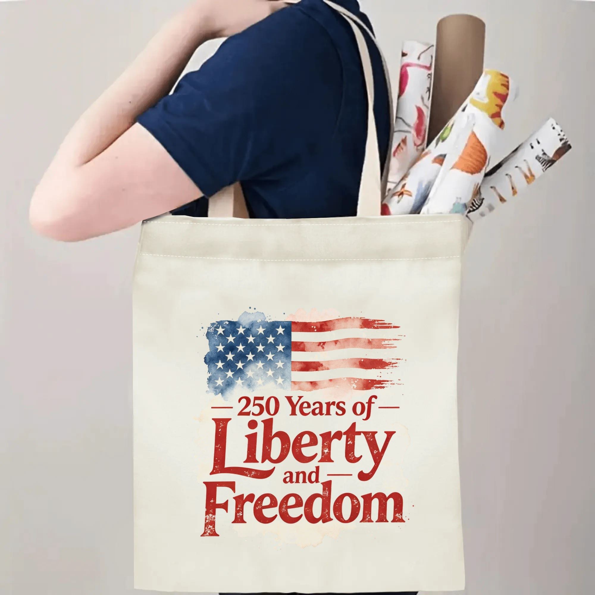 Person wearing the tote bag over their shoulder, showing the print from the side, with rolled-up items peeking out.