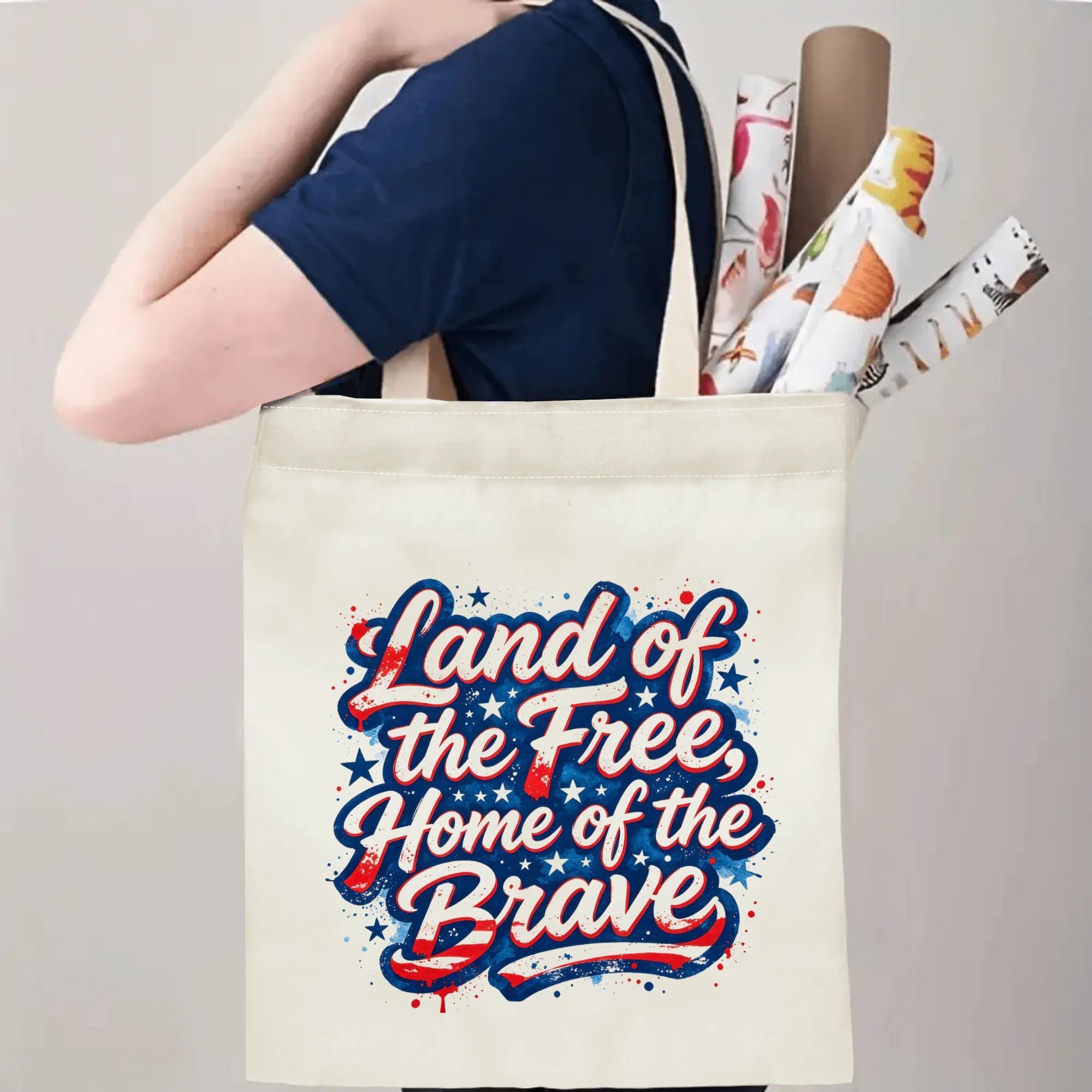 Person wearing the tote bag over their shoulder, showing the print from the side, with rolled-up items peeking out.