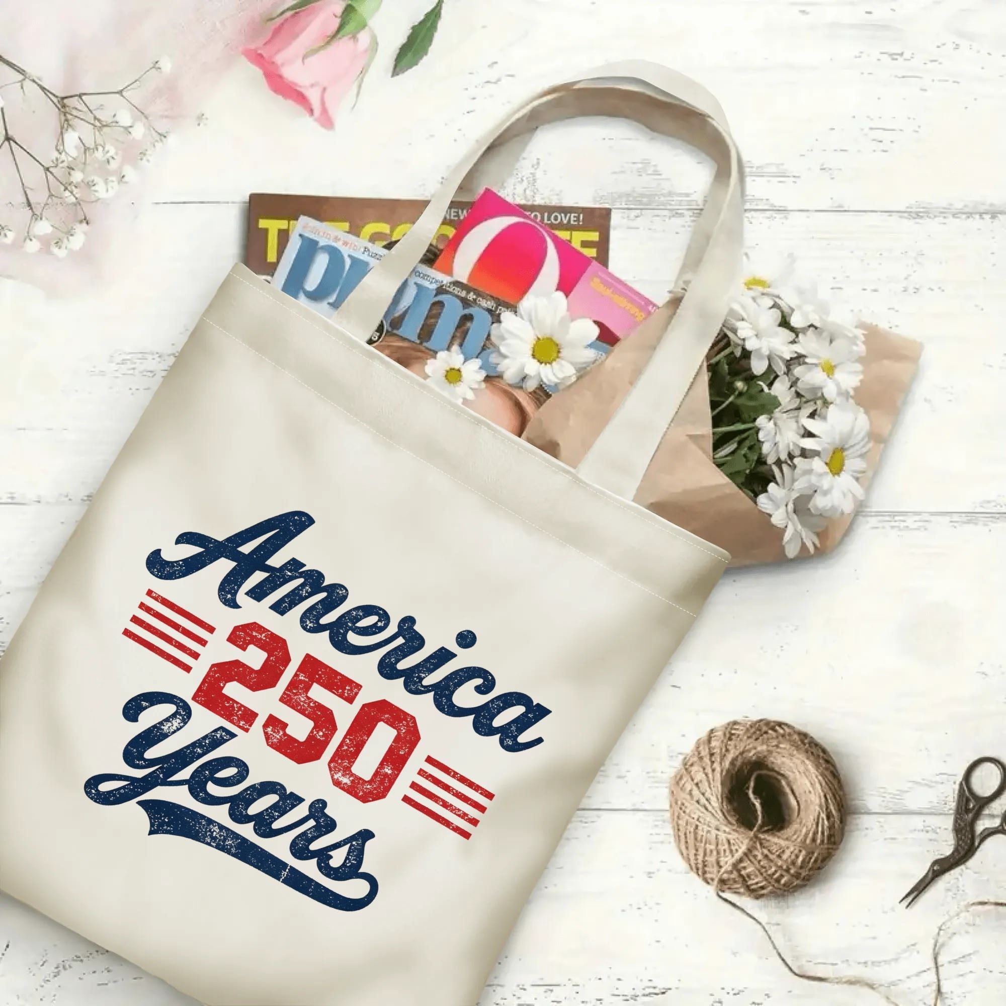 The same tote bag shown open, filled with books, magazines, and flowers, displaying its spacious capacity and print clearly.