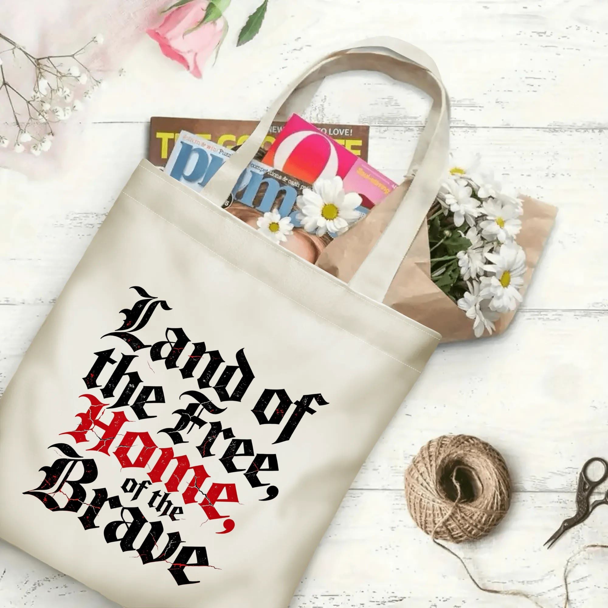 The same tote bag shown open, filled with books, magazines, and flowers, displaying its spacious capacity and print clearly.