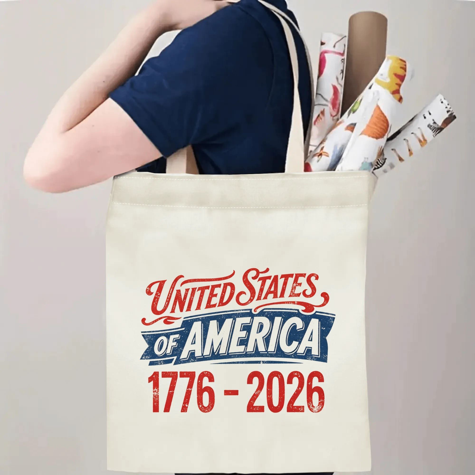 Person wearing the tote bag over their shoulder, showing the print from the side, with rolled-up items peeking out.