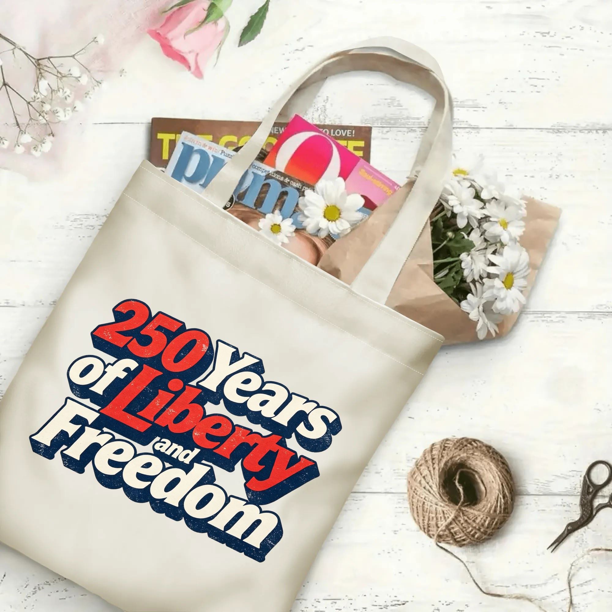 The same tote bag shown open, filled with books, magazines, and flowers, displaying its spacious capacity and print clearly.