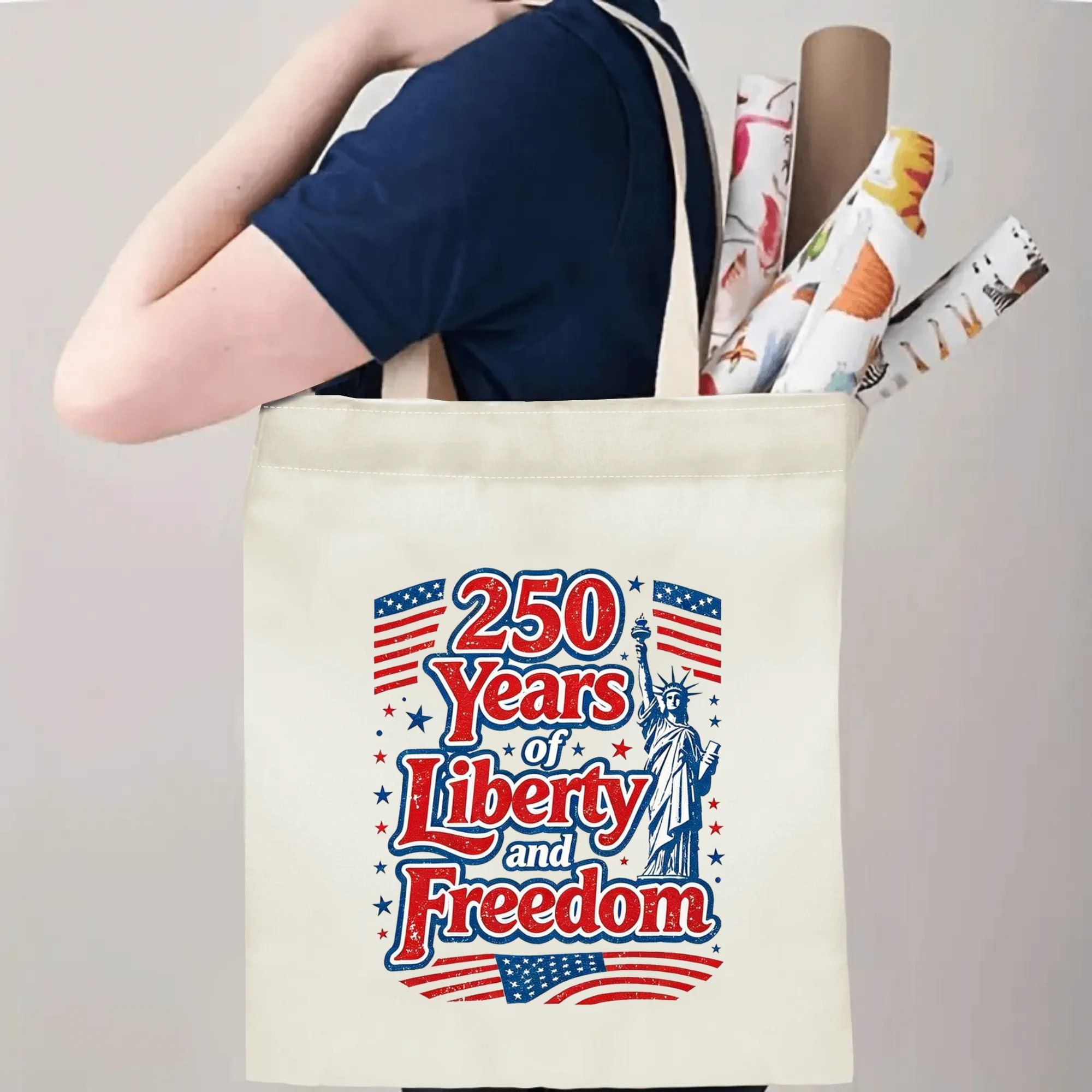 Person wearing the tote bag over their shoulder, showing the print from the side, with rolled-up items peeking out.