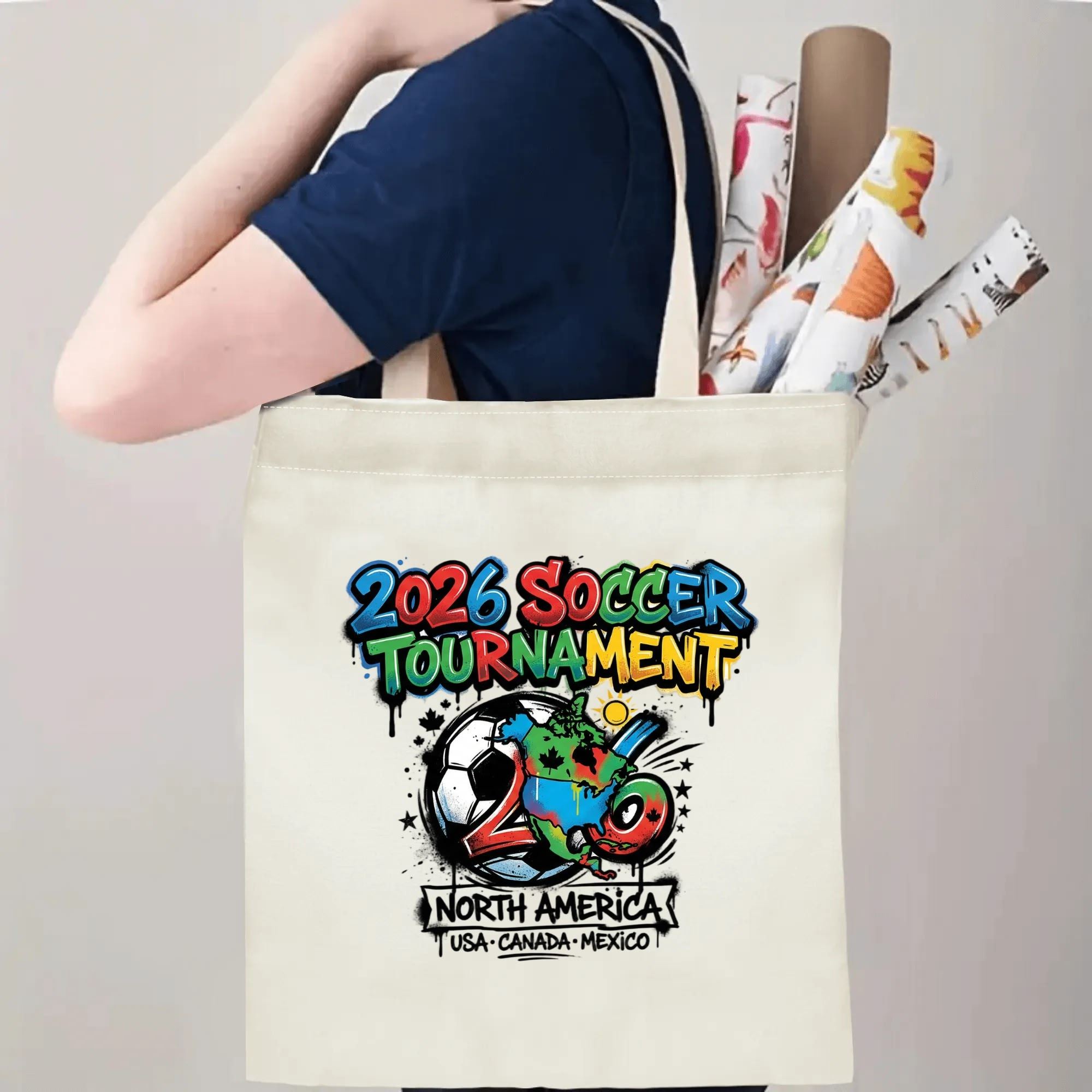 Person slinging 2026 USA Canada Mexico graffiti soccer tote bag over shoulder, large capacity urban football supporter carry bag for stadium trips