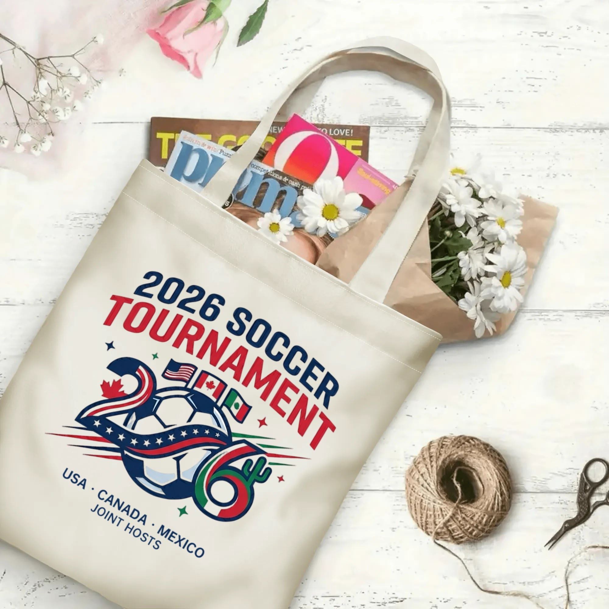 Vintage varsity number flag soccer graphic canvas tote bag laid flat with magazines and daisies, reusable casual sport fan daily shopping bag