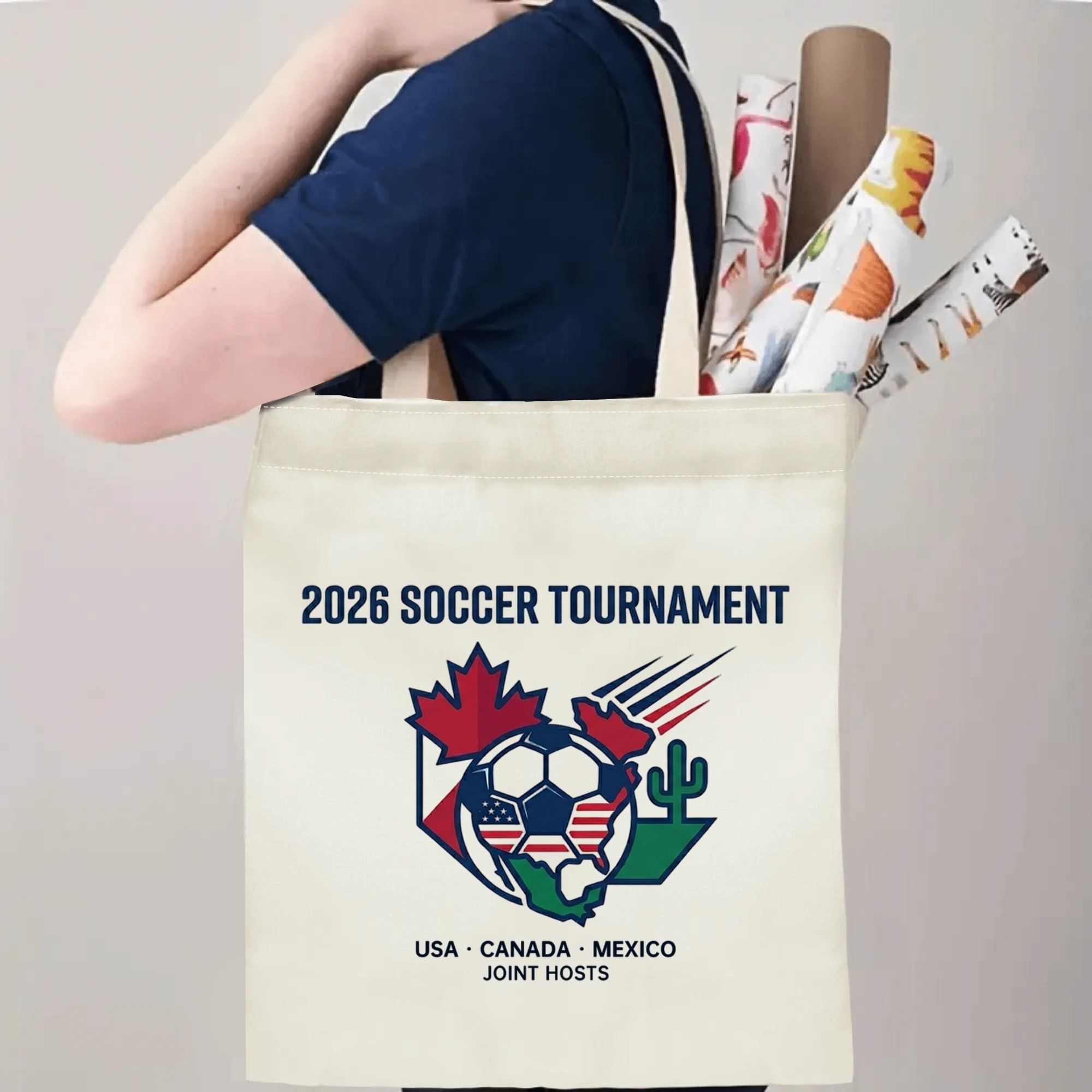 Person slinging minimal 2026 soccer tournament canvas tote bag over shoulder, large capacity quiet patriotic football fan carry bag for stadium trips