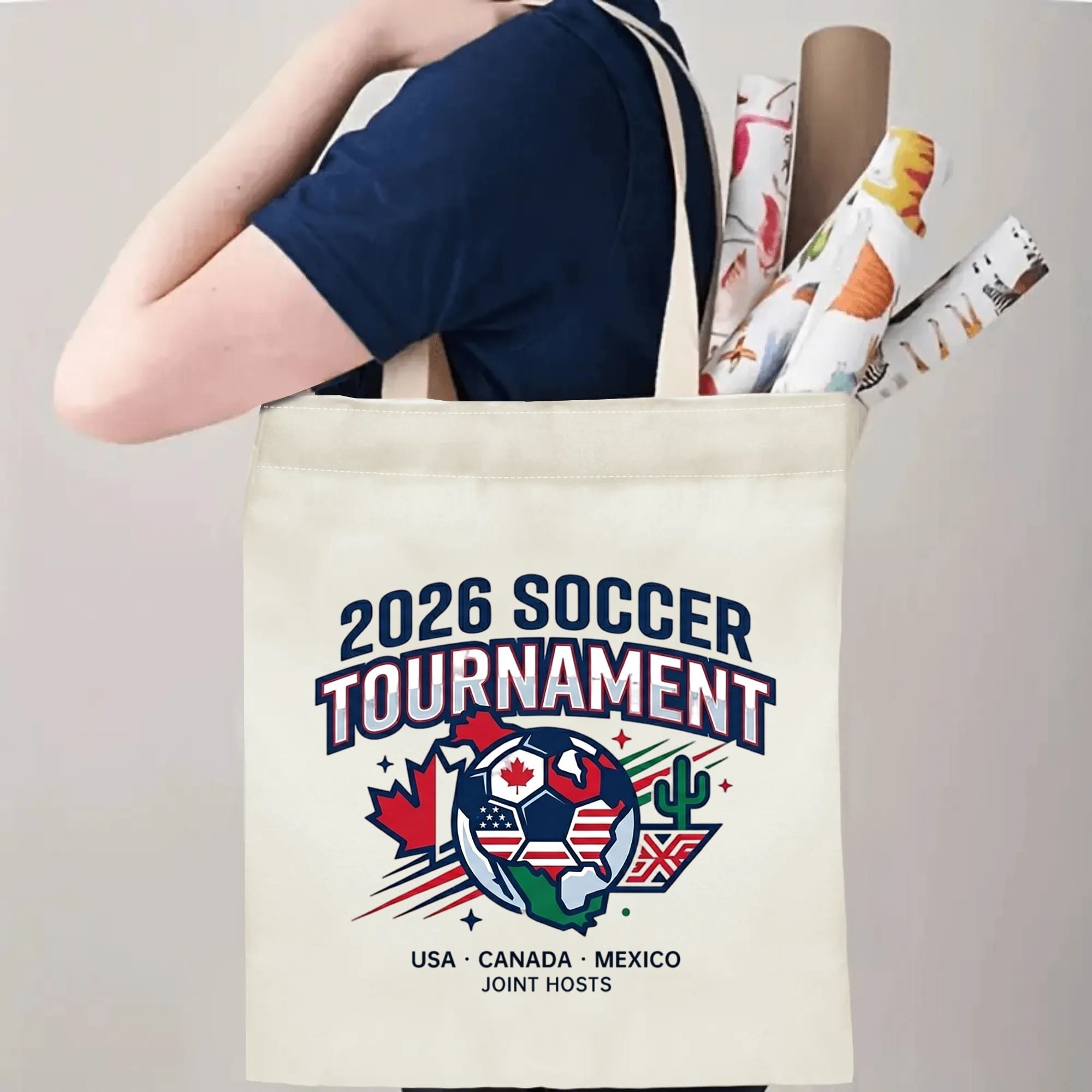 Person slinging 2026 USA Canada Mexico globe soccer badge canvas tote bag over shoulder, large capacity vintage football supporter carry bag for stadium outings