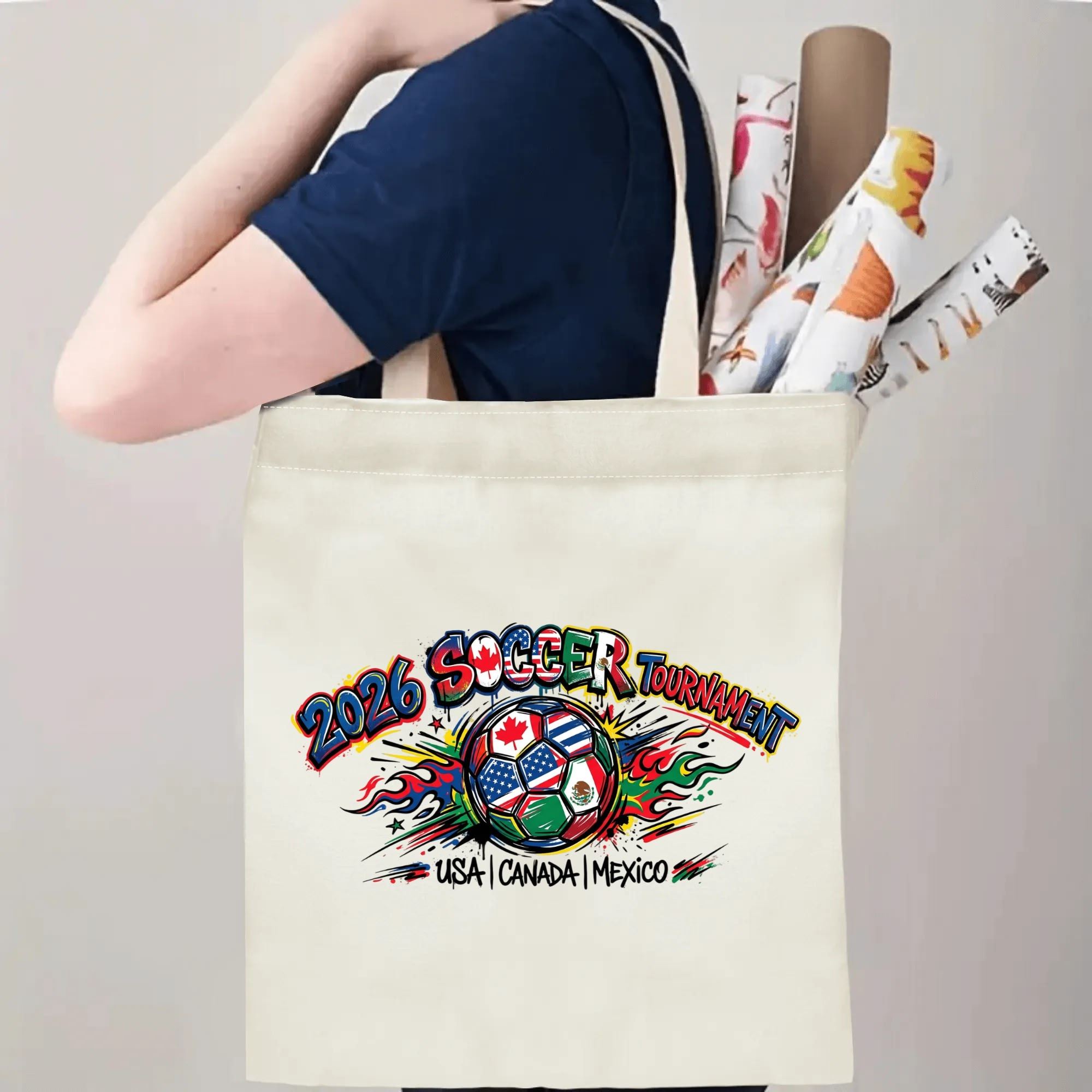 Person slinging 2026 World Cup USA Canada Mexico flame graffiti soccer graphic polyester canvas tote bag over shoulder, large capacity trendy football supporter carry bag for stadium outings