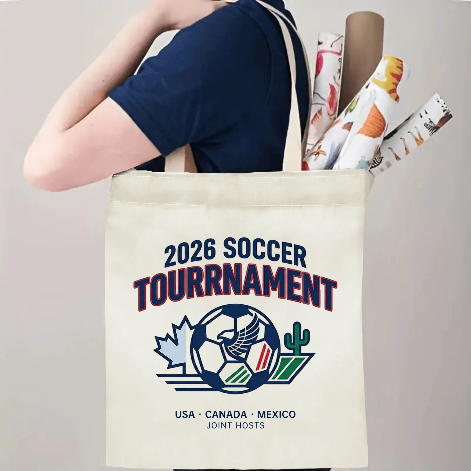 Person slinging 2026 USA Canada Mexico eagle soccer logo tote bag over shoulder, large capacity understated football fan carry bag for stadium trips