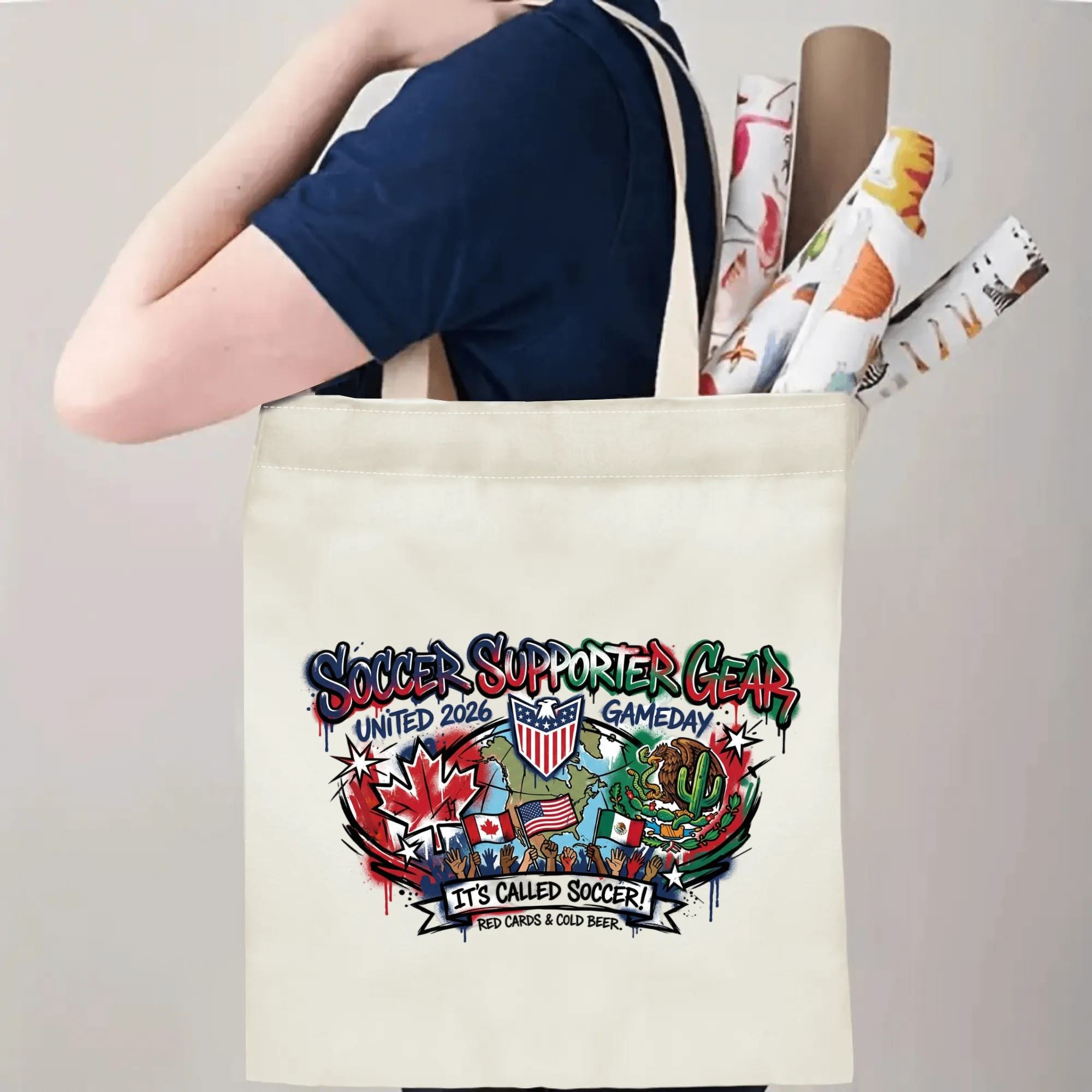 Person slinging bold graffiti "It’s Called Soccer" canvas tote bag over shoulder, large capacity eye-catching football supporter carry bag for stadium trips