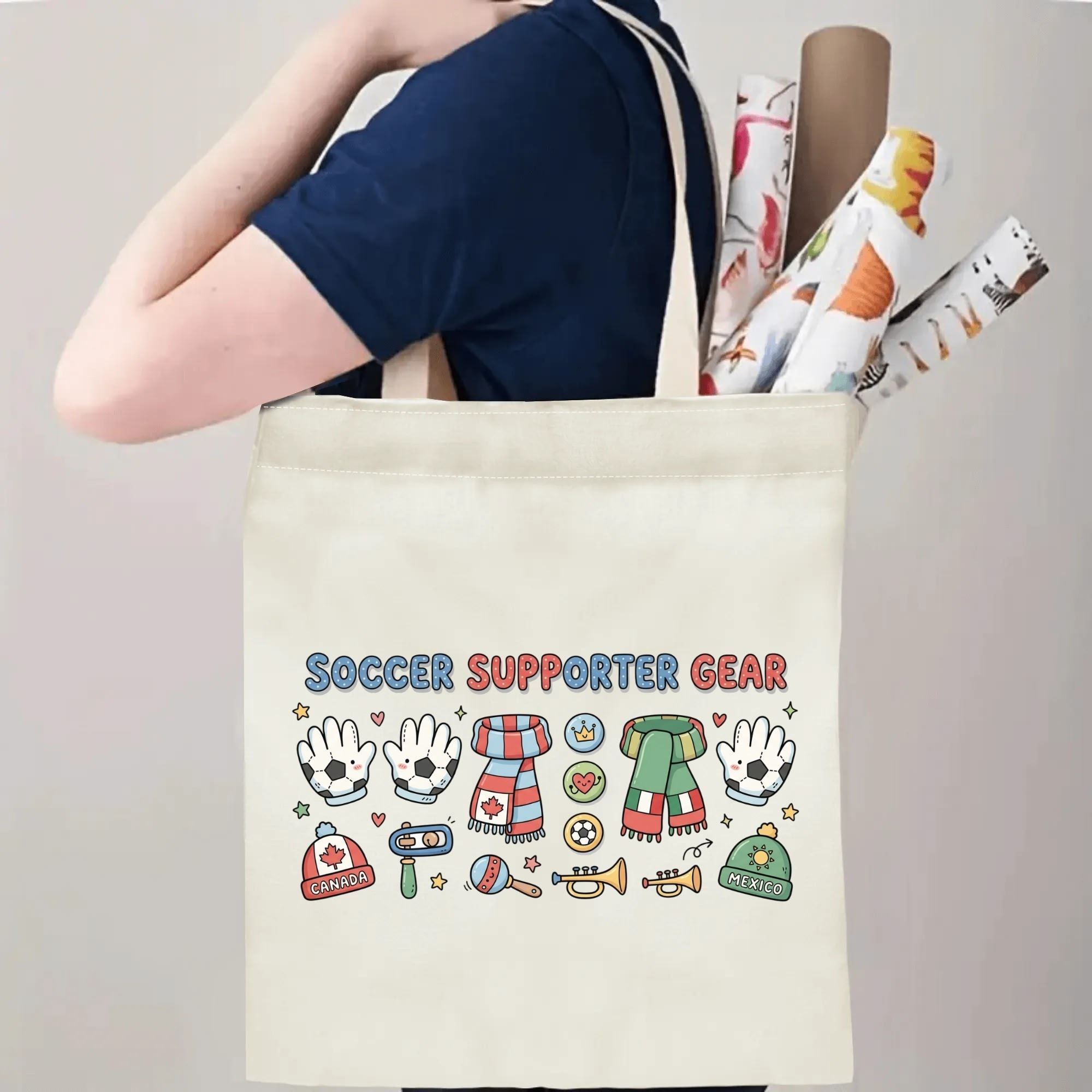 Person slinging 2026 World Cup cute doodle Canada Mexico fan gear polyester canvas tote bag over shoulder, large capacity kawaii football supporter carry bag for stadium outings